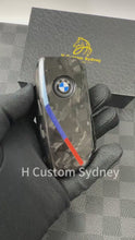 Load and play video in Gallery viewer, Luxury Forged Carbon Fiber Key Fob Cover Case For BMW New 5 7 series i5 i7 iX X5 X6 X7 LCI New Generation Key Exclusive Edition
