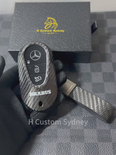 Load and play video in Gallery viewer, Premium Carbon Fiber Key Fob Cover Pack for Mercedes AMG W214 W223 X254 W206 C192 EQ Exclusive Brabus Edition
