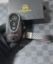 Load and play video in Gallery viewer, Premium Carbon Fiber Key Fob Cover Case For Mercedes AMG New C E GLC S EQ Class W206 X254 W223 C236 W214 X290 Exclusive Pink Edition
